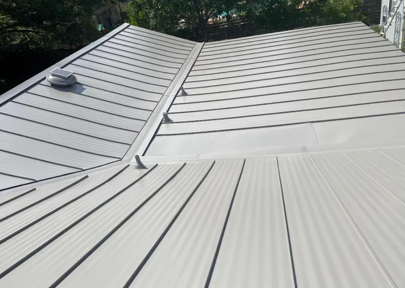 Solar attic fan installed on a metal roof for Roof Ventilation in Pelican Bay